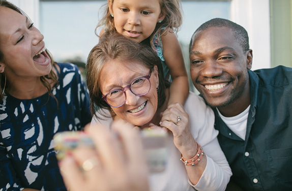 Happy family smiling at phone