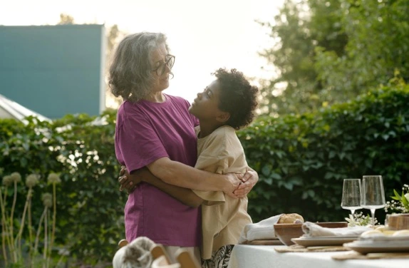 grandmother embracing grandson