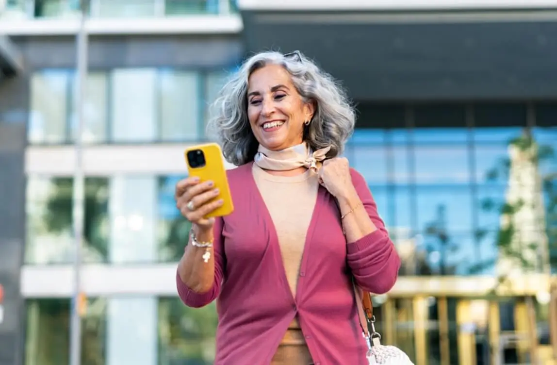 Woman smiling looking at phone