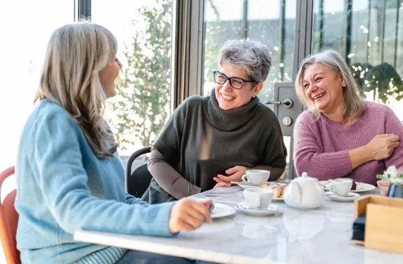 Mature women having tea smiling