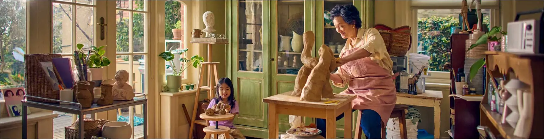 Woman sculpting art with child